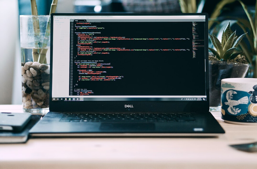 developer writing code on laptop