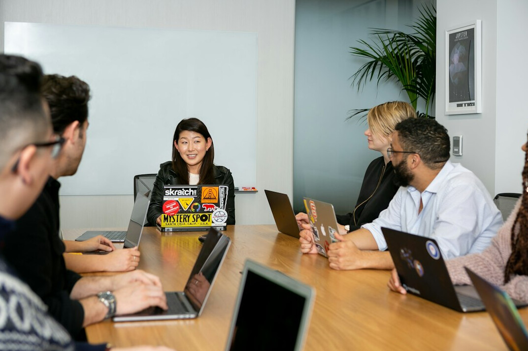 corporate team meeting with laptops
