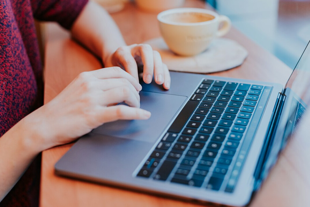 programmer typing on laptop